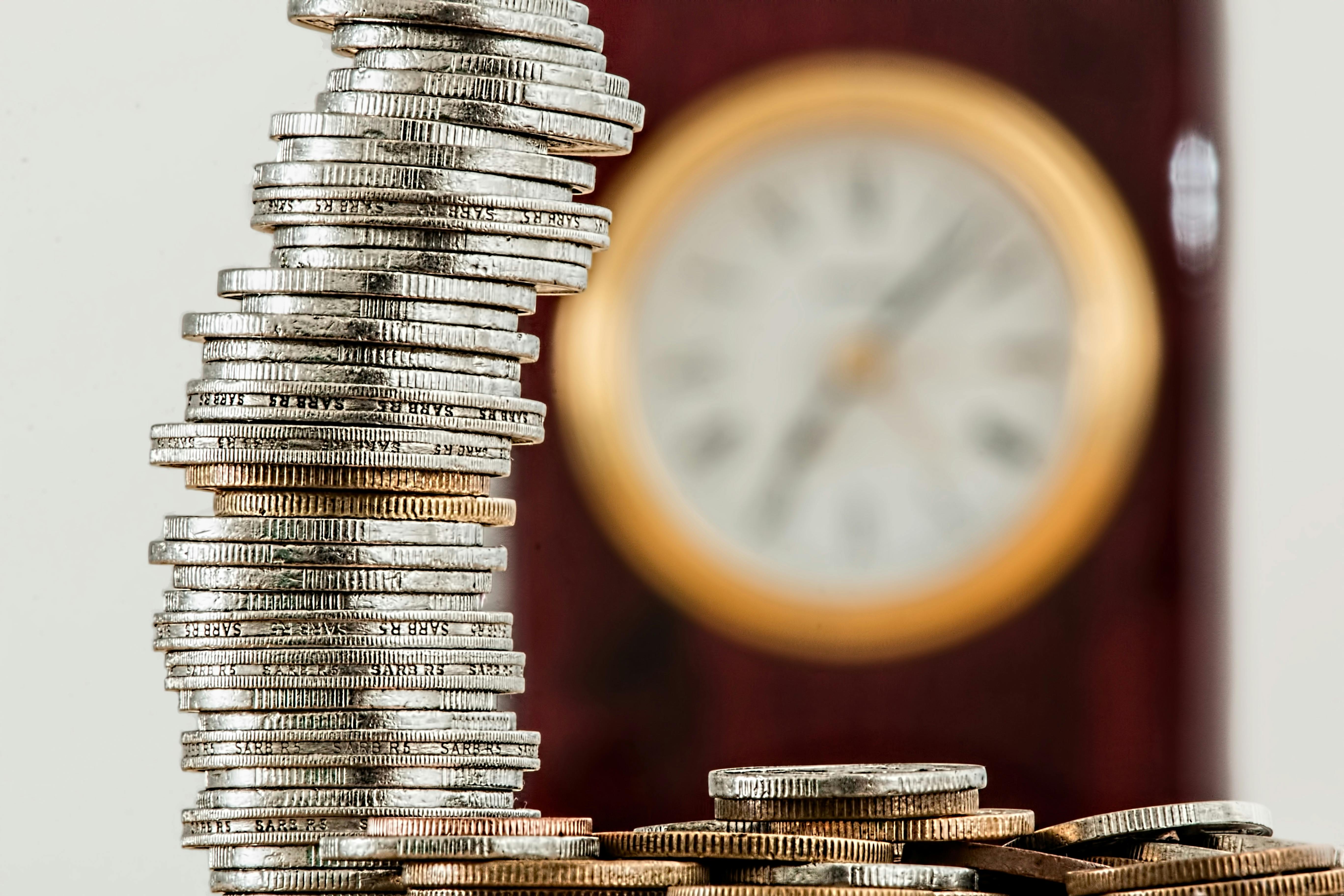 stack of coins with a clock